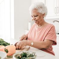 elderly lady cutting vegetables